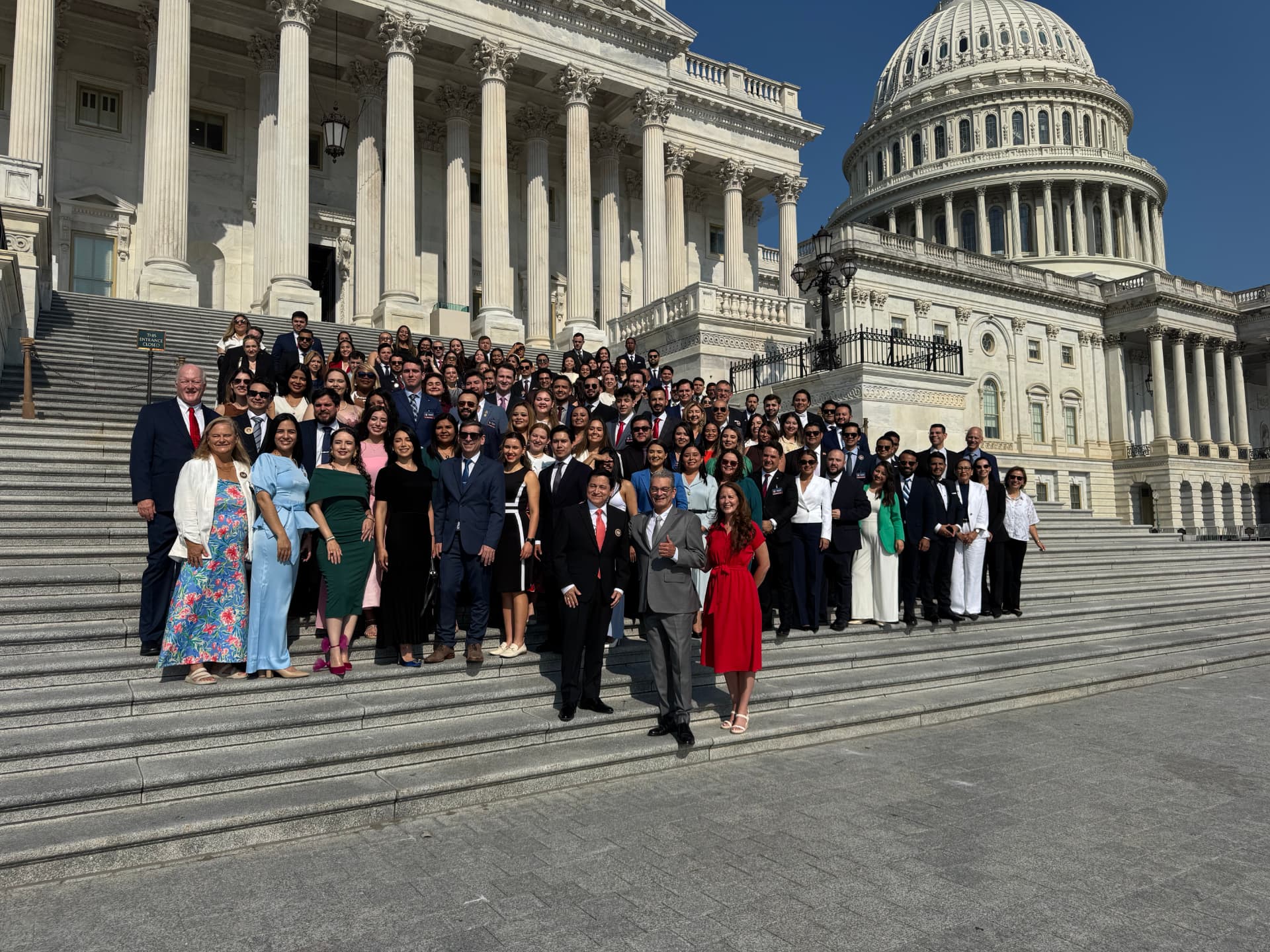A large group of Latin American lawyers and advocates gathered on the steps of the United States Capitol.