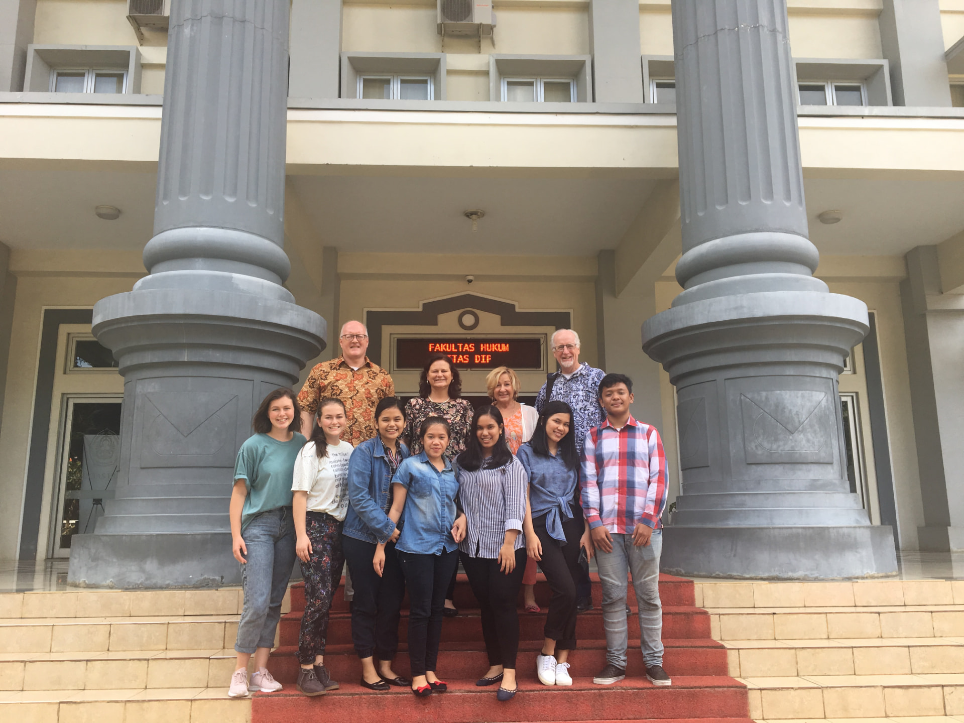 Patrick and Kathleen Talbot with law students on the steps of the Faculty of Law at Diponegoro University in Indonesia.