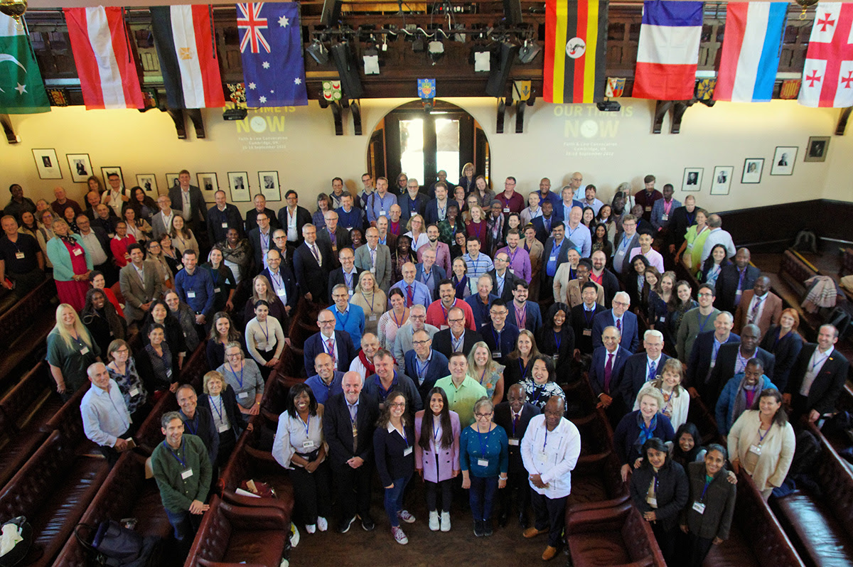 Delegates gathered under the flags of the nations at the Faith and Law Around the Globe conference in Cambridge.