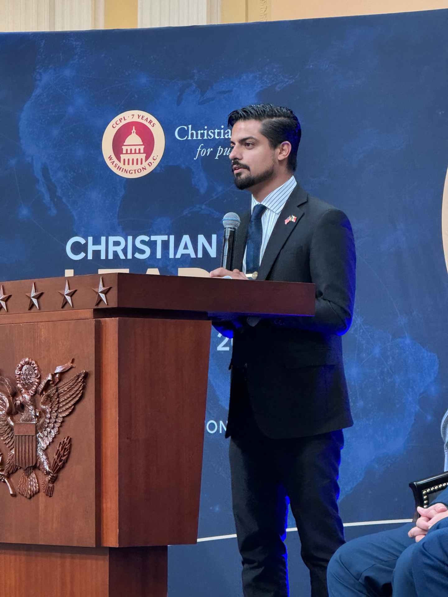 A young advocate speaking at a podium at the Christian Public Leaders Summit in Washington, D.C.